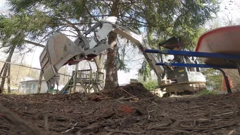 LOW ANGLE EXCAVATOR MOVING DIRT IN YARD Stock Footage 150188478