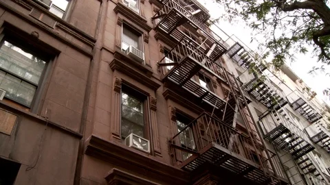 Low angle exterior shot of brownstone East Village apartment building, day. 스톡 동영상 110809233