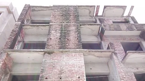 Low angle exterior view of unfinished multi-story brick residential building Video stock 342169326