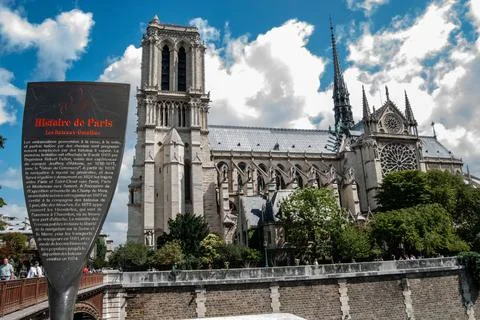 A low angle of the facade of Notre Dame de Paris in France against a cloudy d 스톡 사진