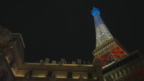 Low angle of fake Eiffel Tower with blue, white, red lights Stock Footage 336669601