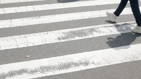 Low angle feet view of Crowded pedestrian people walking crossing zebra lin.. Video stock 340307882