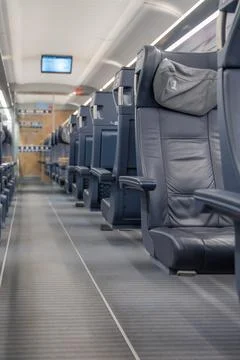 Low angle of first-class leather seats emphasizes legroom and design. Stock Photos