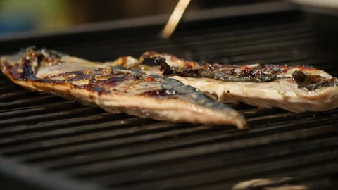 Low angle of fish fillets cooking on a BBQ 動画素材 115057233