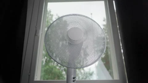 Low angle floor fan by window loop Stock Footage 345865307