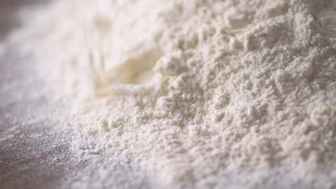 Low angle of flour falling onto mound of flour shot in slow motion 120 fps Stock Footage 171484858
