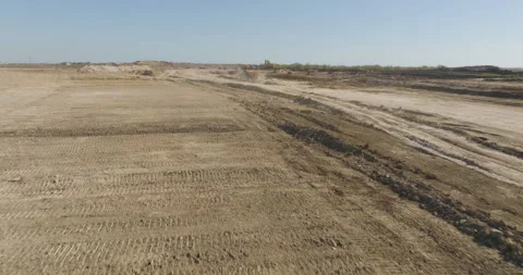 Low Angle Follow of Dump Trucks &amp; Excavator Stock Footage 301668721