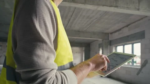Low angle footage of caucasian engineer browsing building project on a digital t Video stock 165044514