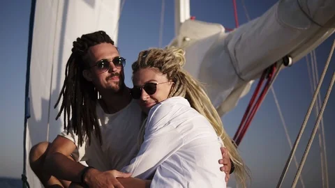 Low angle footage of stylish couple with dreadlocks in white clothes and Stock Footage 118961831