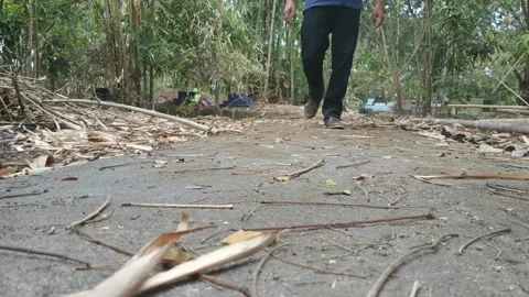 Low angle, footsteps with shoes, away from the grave Stock Footage 145325663