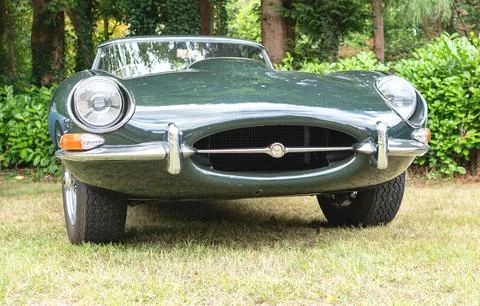 Low angle front view of a classic British green Jaguar E-Type sports car park Fotos Stock