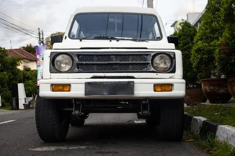 Low Angle Front View of White Classic Compact SUV Jimny Katana Parked on Ur.. Stock Photos