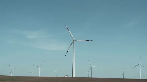 Low angle full shot of wind generators on windmill field with grass Stock Footage 238009086