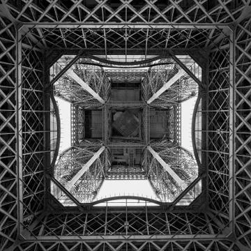 Low angle grayscale shot of the Eiffel tower from the inside in Paris, France Photos