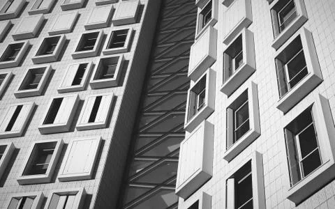 Low angle grayscale shot of a modern white building with rectangular windows Stock Photos