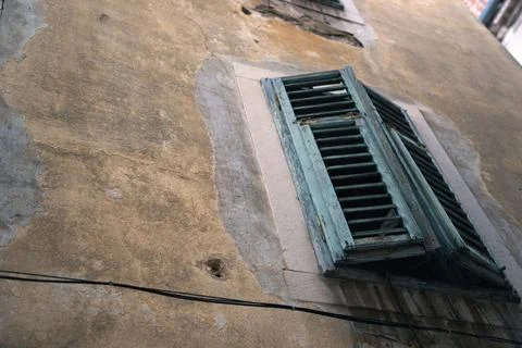 Low angle of green window shutters located on the wall of a building Fotos de archivo