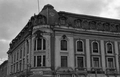 A low angle grey scale shot of an old beautiful building underneath the cloud Stock Photos