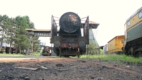 Low angle ground level old rusty steam locomotive in railway museum Stock Footage 138380558