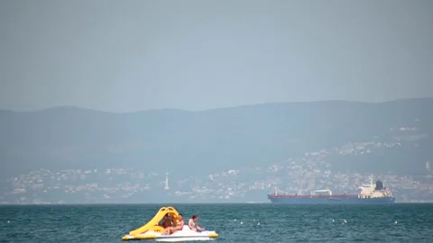 Low angle, ground level view of people on enjoying summer at the sea Stock Footage 172242526