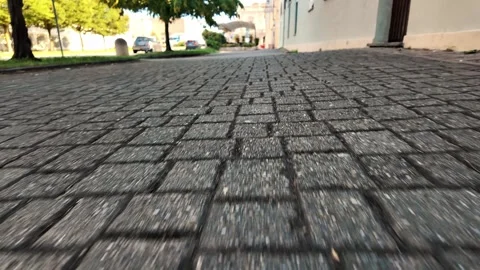 Low angle ground perspective of cobblestone pavement street in town Stock Footage 343792333
