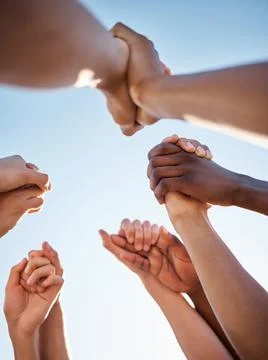 Low angle, group and holding hands in support, trust huddle and motivation for Stock Photos