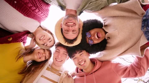 Low angle of group of cheerful young friends in circle taking selfie portrait Stock Footage 192349377