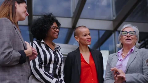 Low angle. Group diverse happy business women gathered talking nodding smiling Stock Footage 316987982