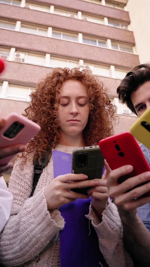 Low angle. Group of young serious people in circle using cell phones together Stock Footage 269241962