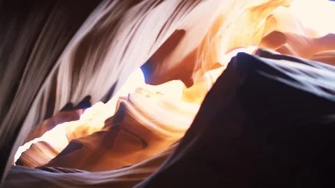 Low angle handheld panning focus rack Antelope slot canyon in Page, Arizona Stock Footage 120606154