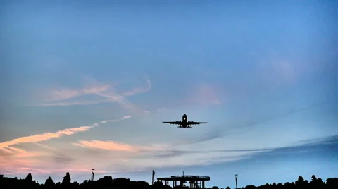 Low angle, high contrast shot of a landing airplane showing airflow. Stock Footage 61720012