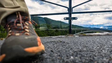 Low-angle hiking boot on mountain overlook with forest valley, Straumen Norwa Stock Photos