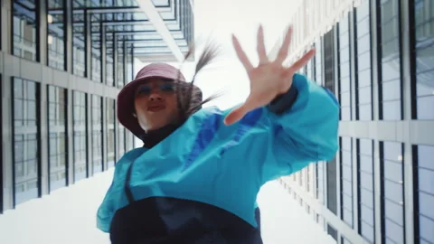 Low angle hip-hop dance, 80s vintage fashion woman dancing outdoors in city Stock Footage 276168084