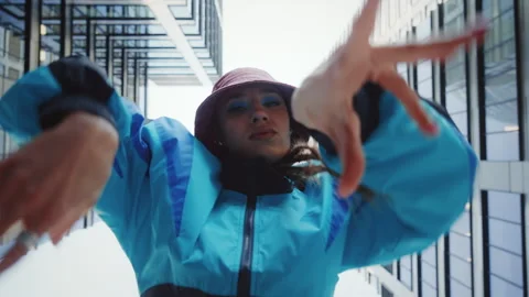 Low angle hip-hop dance, 80s vintage fashion woman dancing outdoors in city Stock Footage 277306363