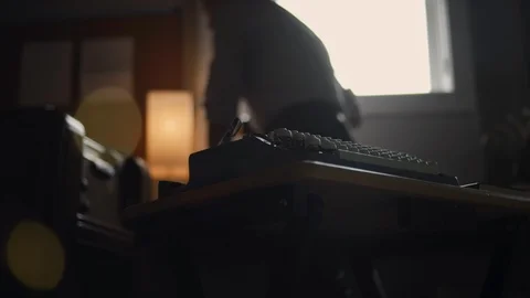 Low angle of a hipster man taking a picture of a vintage typewriter in an office Stock Footage 97870749