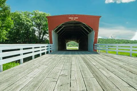 Low angle of Hogback Covered Bridge with road planks and blue skies Stock Photos