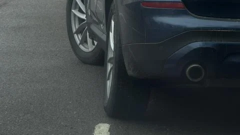 Low angle horizontal shot showing the rear wheel, tire, and dual exhaust system Stock Photos