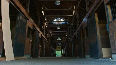 Low angle interior of unfinished horse stables under construction Stock Footage 117743716