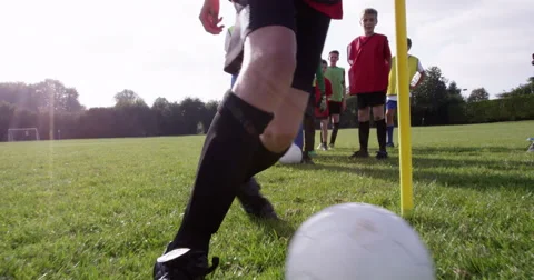 Low angle of kids training with a soccer ball on a field. Shot  on RED Epic. Stock Footage 56744070