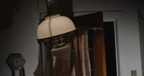 Low Angle on Lamp Swinging in Dark Kitchen 스톡 동영상 125911993