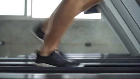 Low angle of leg and shoes man running on treadmill in fitness gym at sport c Stock Footage 162802388
