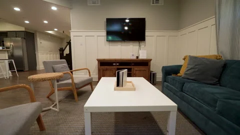 Low angle living room with teal sofa and white coffee table Stock Footage 345687826