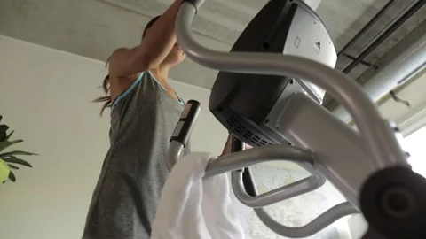 Low angle lockdown shot of determined woman exercising on treadmill at home Video stock 77782073