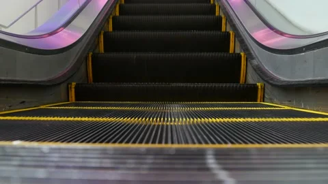 Low angle looped perspective view of modern escalator stairs. Automated elevator Stock Footage 141415304