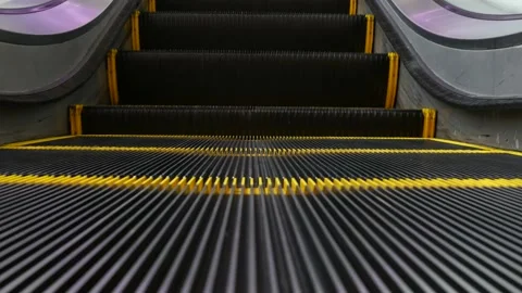 Low angle looped perspective view of modern escalator stairs. Automated elevator Stock Footage 141571074