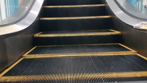 Low angle looped perspective view of modern escalator stairs. Automated ele.. Stock Footage 272840646