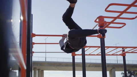 Low angle of a man exercising on the bar. Outdoor exercise. Concept of health Stock Footage 147695654