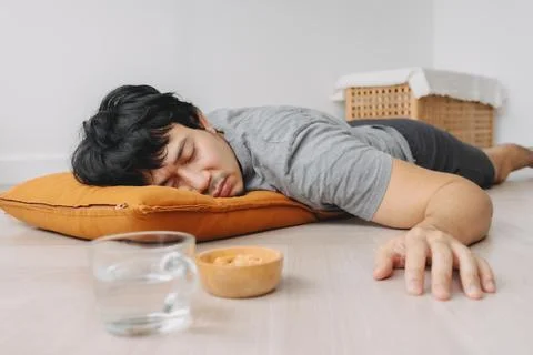 Low angle of man napping on the floor take a rest in the weekend. Photos