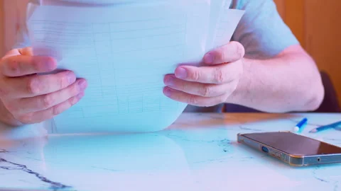 Low angle a man sorting paper documents. Stock Footage 336696225