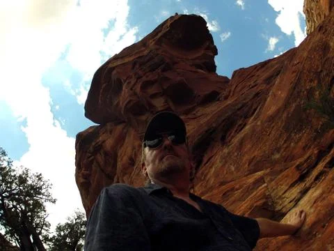 Low Angle Man Standing Under Sedona AZ Rock Formation Stock Photos