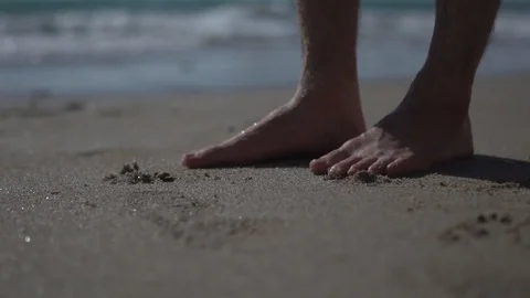 Low angle on man walking, stepping at beach. barefoot slow motion Stock Footage 100167741